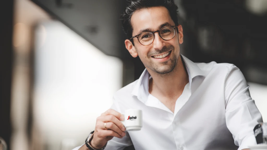 Man in office drinks Segafredo coffee.jpg